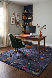 5' x 7' Rectangular Navy Blue Multicolor Tribal Geometric Bohemian Area Rug styled in a home office with a wooden desk and green office chair.