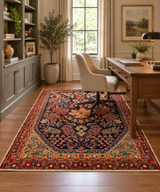 5' x 7' Rectangular Navy Blue & Red Floral Medallion Traditional Oriental Area Rug styled in a home office with a wooden desk and beige upholstered chair.