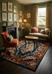 5' x 7' Rectangular Navy Blue & Rust Orange Floral Ornate Traditional Area Rug styled in a living room with a rust velvet accent chair and floral loveseat.