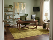 5' x 7' Rectangular Olive Green & Gold Solid Textured Modern Washable Area Rug styled in a home office with a wooden desk and green upholstered chair.