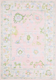 5' x 7' Rectangular Pink Multicolor Floral Traditional Washable Area Rug displayed on a white background, highlighting its delicate floral motifs and pastel pink, green, and blue accents.