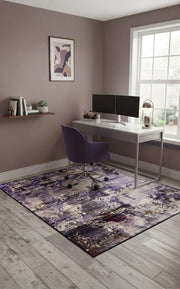 5' x 7' Rectangular Purple Lavender Gray Distressed Abstract Modern Area Rug styled in a home office with a white desk and purple office chair.