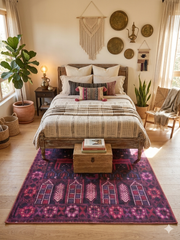 5' x 7' Rectangular Purple & Pink Tribal Southwestern Washable Area Rug styled in a warm boho bedroom under a rustic wooden bed.