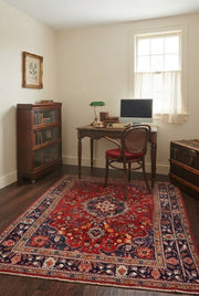 5' x 7' Rectangular Red Navy Blue Floral Medallion Traditional Oriental Washable Area Rug placed in a home office with a wooden desk and vintage cane chair.