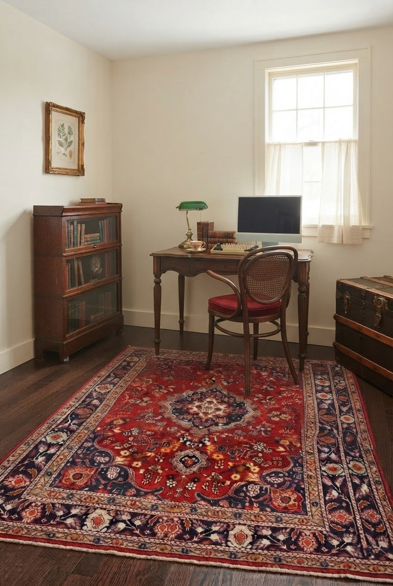 5' x 7' Rectangular Red Navy Blue Floral Medallion Traditional Oriental Washable Area Rug placed in a home office with a wooden desk and vintage cane chair.