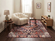 5' x 7' Rectangular Rust Red & Burgundy Floral Medallion Traditional Vintage Area Rug styled in a cozy living room with a cream accent chair and wooden coffee table.