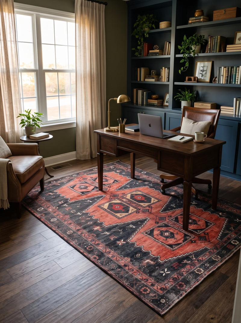 5' x 7' Rectangular Rust Red & Charcoal Black Tribal Geometric Medallion Traditional Area Rug styled in a home office with a dark wooden desk and brown leather office chair.