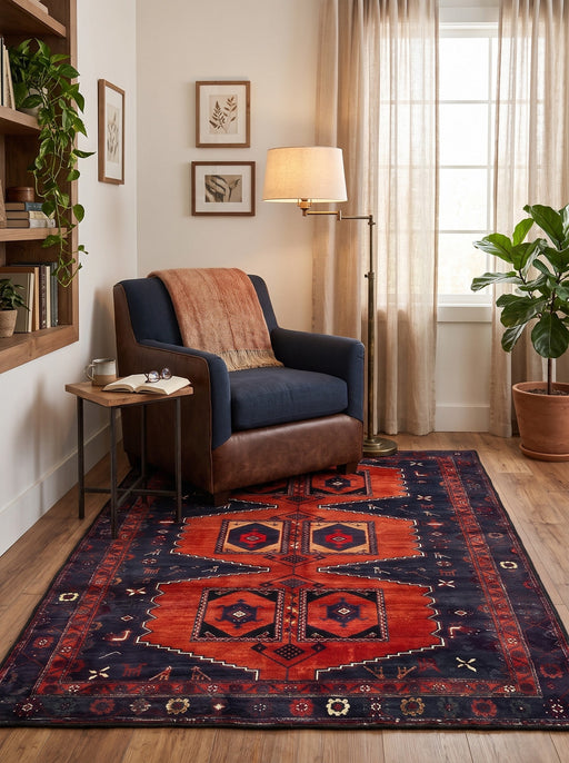5' x 7' Rectangular Rust Red & Navy Blue Tribal Geometric Medallion Traditional Area Rug styled in a cozy reading area with a navy armchair and wooden side table.