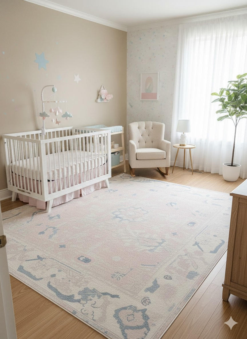 5' x 7' ivory cream blush pink washable abstract vintage area rug styled in a soft nursery space with a white crib, rocking chair, and airy natural light.