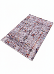 5' x 7' purple tonal rectangular area rug displayed on a clean white background highlighting the modern abstract pattern