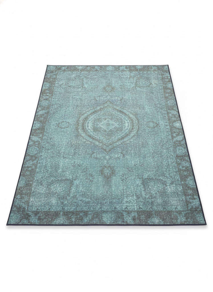 5' x 7' teal blue distressed traditional area rug featuring subtle vintage detailing with a washable non-slip backing.