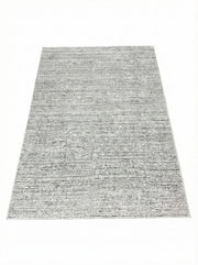 5' x 7' washable area rug featuring a soft gray and ivory heathered texture with subtle warm beige undertones for a versatile neutral look.