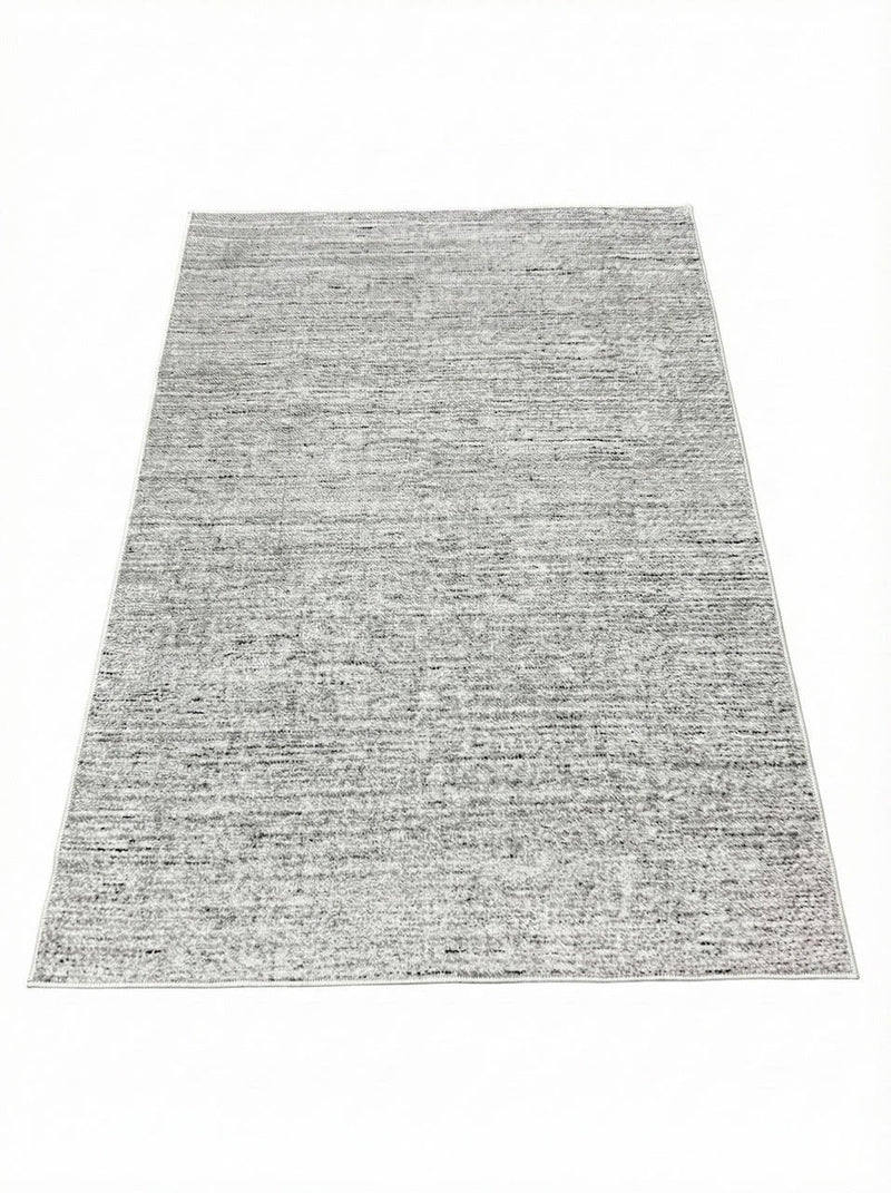 5' x 7' washable area rug featuring a soft gray and ivory heathered texture with subtle warm beige undertones for a versatile neutral look.