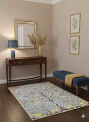 5' x 8' Blue Cream Soft Yellow Floral Traditional Area Rug placed in a welcoming entryway with wood floors and console table.