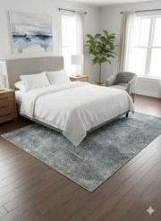 5' x 8' Blue Gray Ivory Solid Modern Rectangular Area Rug styled in an elegant bedroom with wood nightstands.