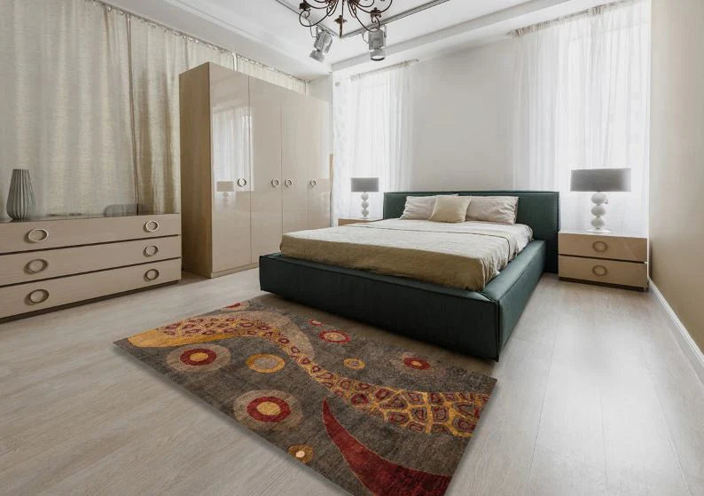 5' x 8' Dark Gold Brown Multi Color Abstract Oriental Area Rug styled in a bedroom setting, demonstrating how the warm brown and gold tones complement neutral furniture.