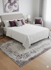 5' x 8' Ivory & Gray Charcoal Distressed Floral Traditional Rectangular Area Rug styled in a modern bedroom beneath a neutral upholstered bed with soft bedding and light wood flooring.