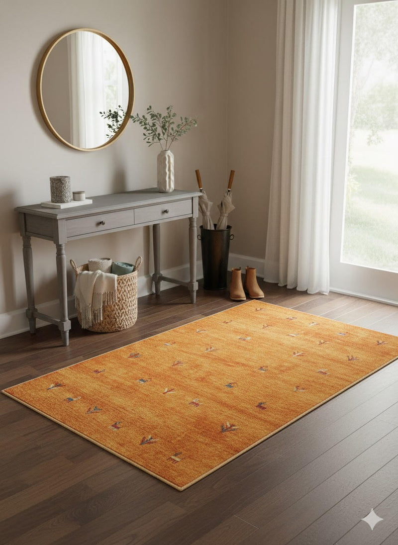5' x 8' Rectangle Gold Rust Brown Ivory Tribal Minimalist Area Rug displayed in an entryway with a console table, round mirror, and decorative baskets for a welcoming look.