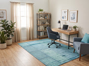 5' x 8' Rectangular Aqua Blue & Teal Distressed Geometric Rectangular Grid Modern Contemporary Area Rug styled in a home office with a wooden desk and blue upholstered office chair.