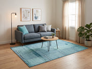 5' x 8' Rectangular Aqua Blue & Teal Distressed Geometric Rectangular Grid Modern Contemporary Area Rug styled in a living room with a gray sofa and round wooden coffee table.