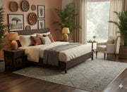5' x 8' Rectangular Blue Beige Ivory Geometric Tribal Area Rug displayed in a warm bedroom setting showing how the geometric tribal design complements natural wood furniture.