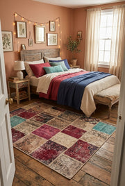 5' x 8' Rectangular Burgundy Pink & Beige Distressed Patchwork Vintage Area Rug placed in a bedroom with a rustic wooden bed and colorful bedding.