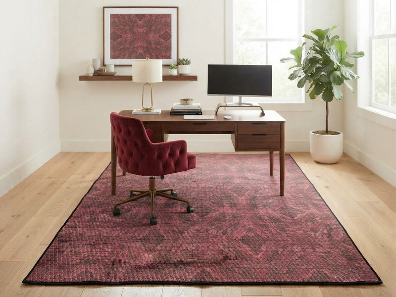 5' x 8' Rectangular Burgundy Red & Black Distressed Geometric Modern Area Rug styled in a home office with a wooden desk and burgundy office chair.