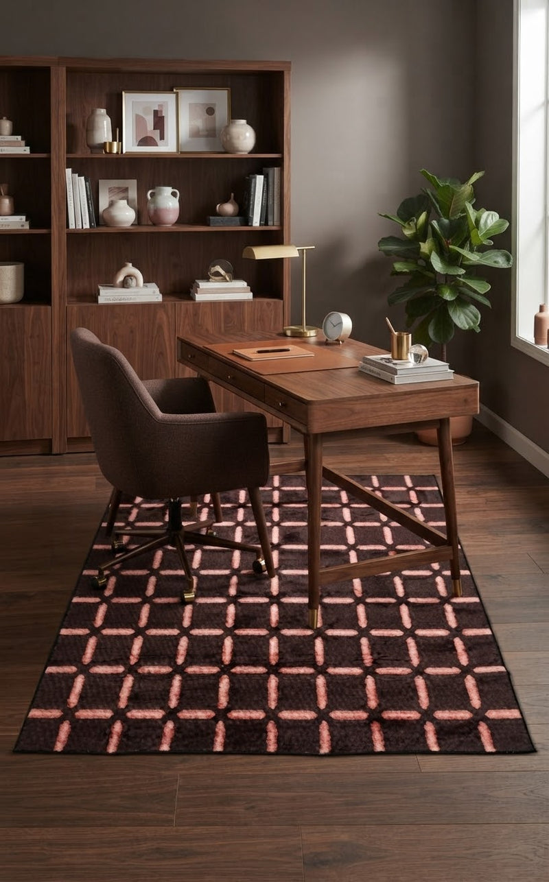 5' x 8' Rectangular Dark Brown & Blush Pink Geometric Grid Modern Area Rug styled in a home office with a wooden desk and brown upholstered chair.