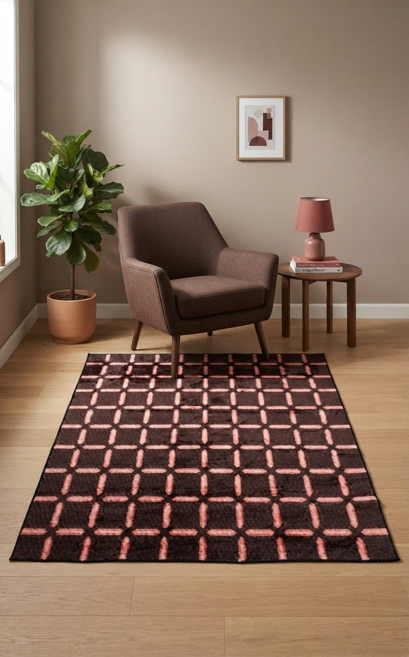 5' x 8' Rectangular Dark Brown & Blush Pink Geometric Grid Modern Area Rug styled in a living room with a brown accent chair and wooden side table.