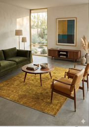5' x 8' Rectangular Gold & Mustard Distressed Floral Traditional Washable Area Rug styled in a living room with green seating and natural light.