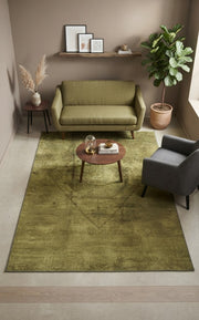 5' x 8' Rectangular Olive Green & Dark Olive Distressed Medallion Vintage Washable Area Rug styled in a living room with an olive green sofa and wooden coffee table.