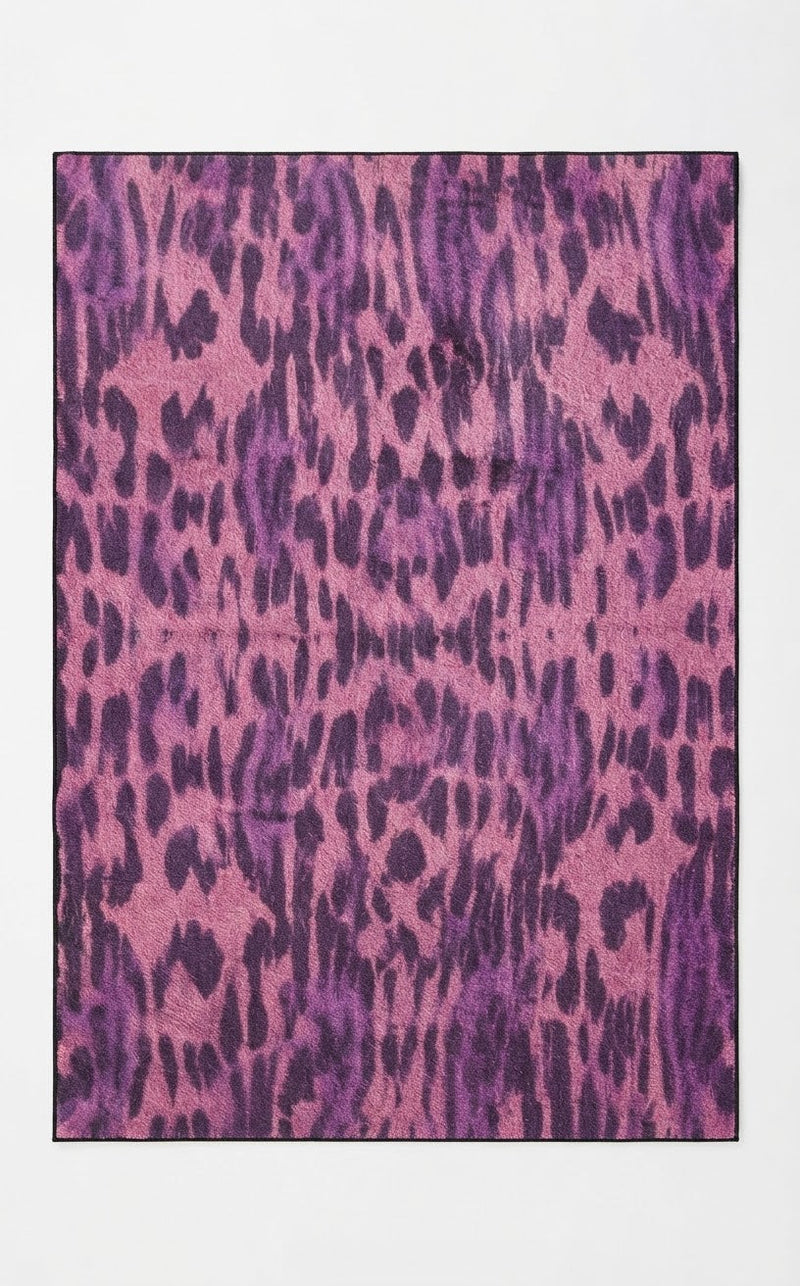 5' x 8' Rectangular Pink & Purple Animal Print Modern Contemporary Area Rug featuring bold leopard-inspired spots and an abstract animal pattern.