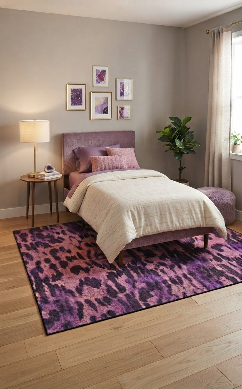 5' x 8' Rectangular Pink & Purple Animal Print Modern Contemporary Area Rug placed in a bedroom with a mauve upholstered bed and cream bedding.
