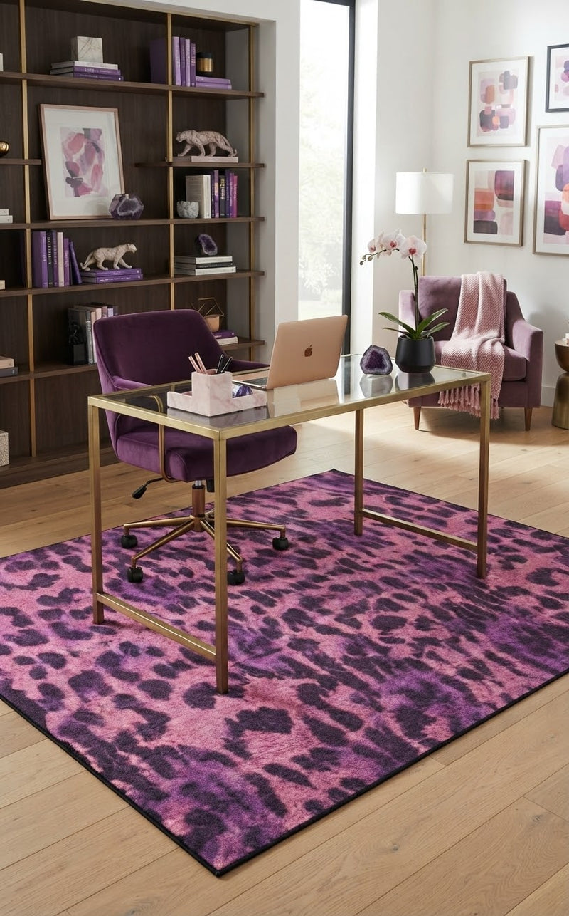 5' x 8' Rectangular Pink & Purple Animal Print Modern Contemporary Area Rug styled in a home office with a glass desk and purple velvet office chair.