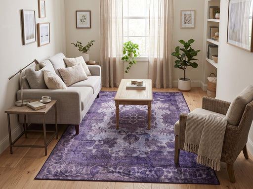 5' x 8' Rectangular Purple & Lavender Distressed Floral Medallion Vintage Traditional Area Rug styled in a living room with a beige sofa, wooden coffee table, and woven accent chair.