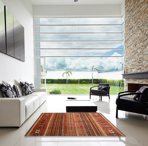 5' x 8' Rectangular Red Multi Color Contemporary Oriental Area Rug styled in a bright modern living room with white sofa and large windows.