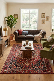 5' x 8' Rectangular Red Navy & Ivory Floral Medallion Traditional Area Rug styled in a living room with a brown leather sofa and green accent chairs.