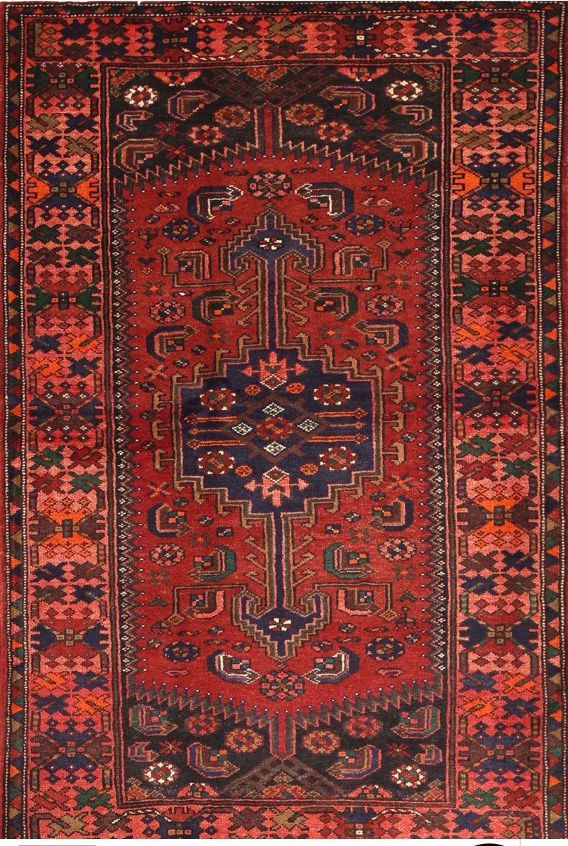 5' x 8' Rectangular Red & Navy Tribal Geometric Traditional Washable Area Rug isolated on a white background.