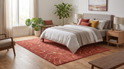 5' x 8' Rectangular Terracotta Red & Mustard Gold Abstract Wavy Contour Line Modern Contemporary Area Rug placed beneath a bed with white bedding and wooden nightstands.