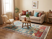 5' x 8' Rectangular Turquoise Blue & Rust Red Pictorial Animal Traditional Area Rug styled in a living room with a beige sofa and rattan accent chair.