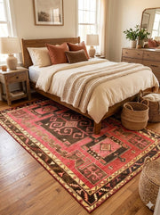 5' x 8' Red Brown Gold Vintage-Inspired Geometric Area Rug placed in a cozy bedroom setting.
