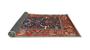 5' x 8' Red and Blue Mid-Century Modern Oriental Area Rug rolled edge view displaying the flexible backing and overall construction.
