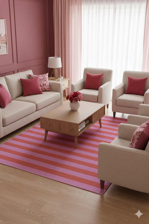 5' x 8' pink and red washable striped modern area rug styled in a contemporary living room with neutral furniture and blush accent pillows.