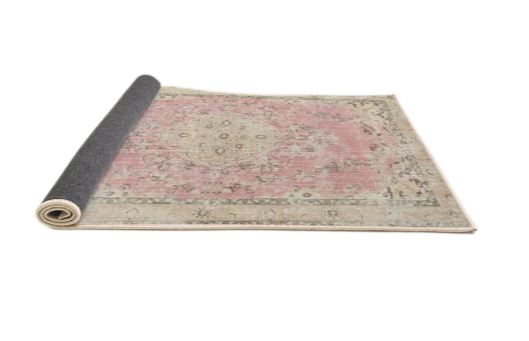 5ft Round Desert Sand Beige Pink Traditional Medallion Area Rug rolled corner view showing the flexible backing and finished edges.