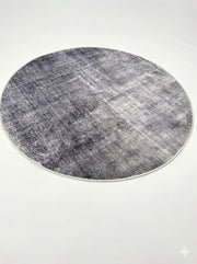 6' round charcoal ivory light beige distressed modern area rug featuring a subtle abstract textured pattern with soft tonal variation.