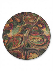 6' round multi color green, burgundy & gold abstract swirl contemporary area rug placed in a cozy room with natural lighting.