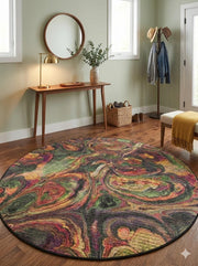 6' round multi color green, burgundy & gold abstract swirl contemporary area rug placed / styled in a modern entryway with a wooden bench, round wall mirror, and coat hooks.