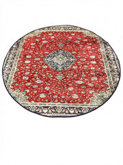 6' round red blue cream traditional area rug featuring an ornate floral medallion center with detailed cream and navy border.