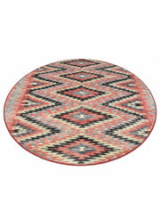 6' round rust & cream southwestern geometric area rug displayed on a light neutral background.