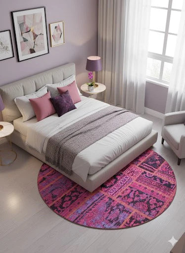6' x 6' Round Pink & Purple Distressed Patchwork Bohemian Area Rug placed in a soft pastel bedroom under bed.